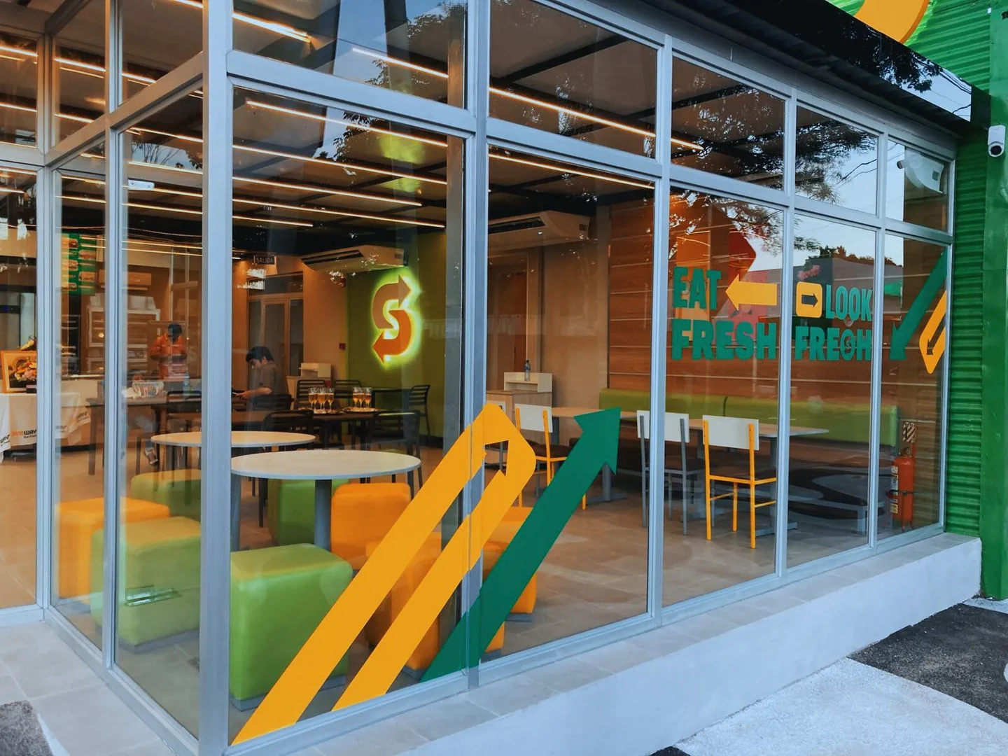 Frente de vidrio y aluminio de un local comercial construido por H34